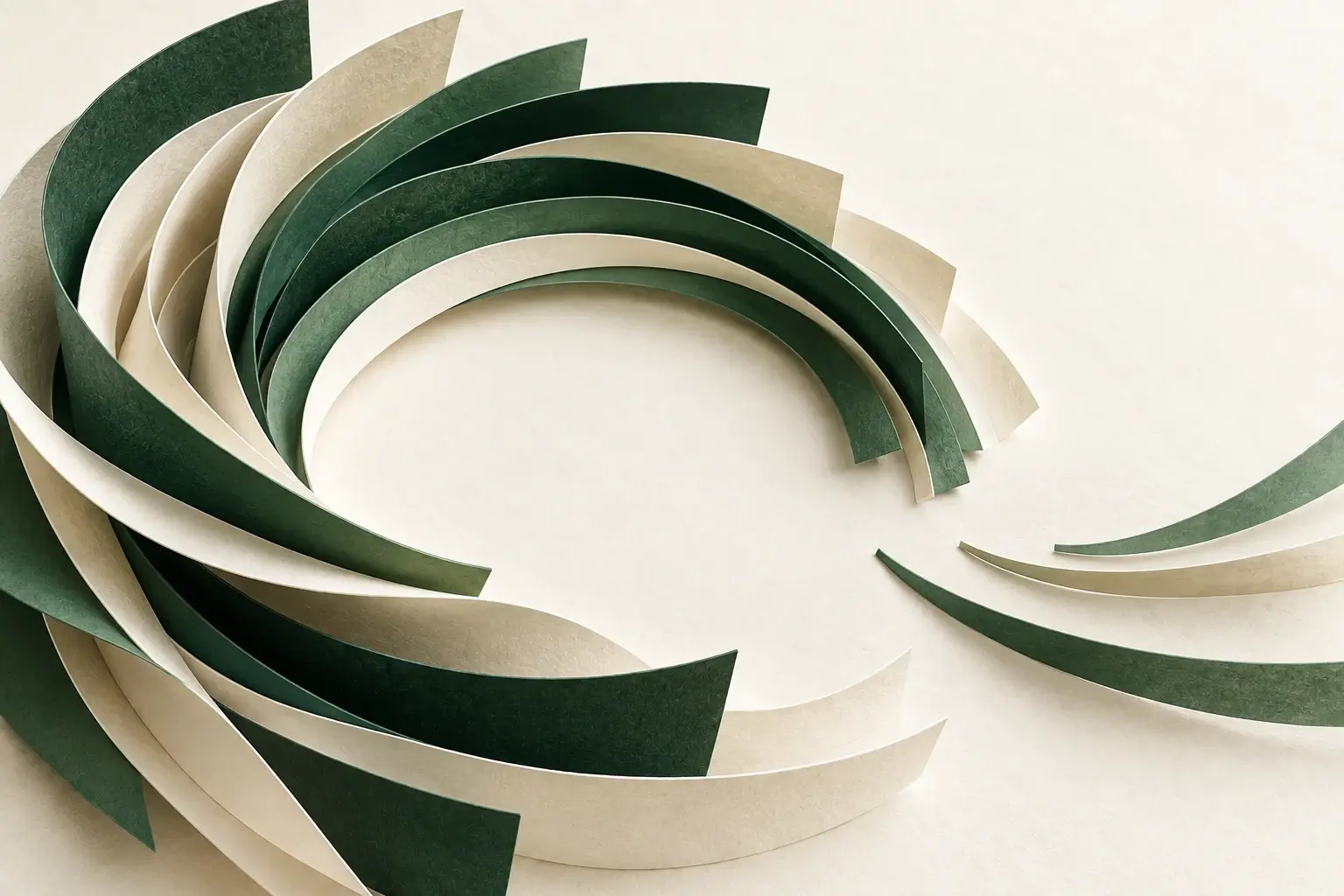 Forest-green and cream paper arcs forming an open ring with layers continuing outward